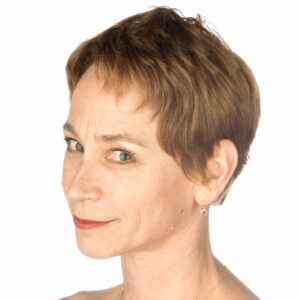 Cynthia Quinn headshot looking at camera with a white background