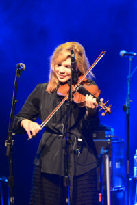 Alison Krauss playing a violin on stage