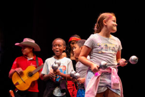Local K-12 Students joined Cimarrón onstage with maracas.