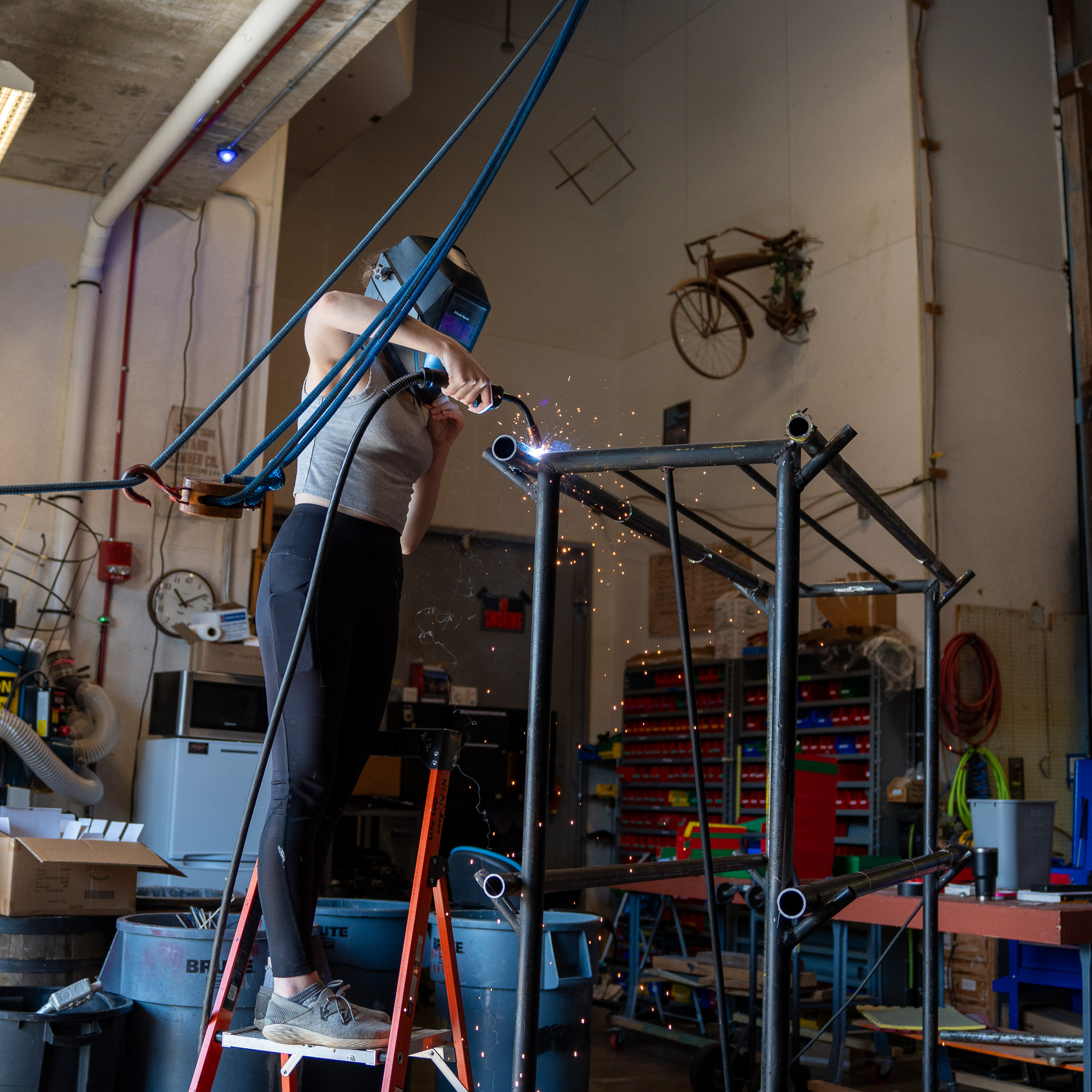 Laura Taylor welds a lighting rack