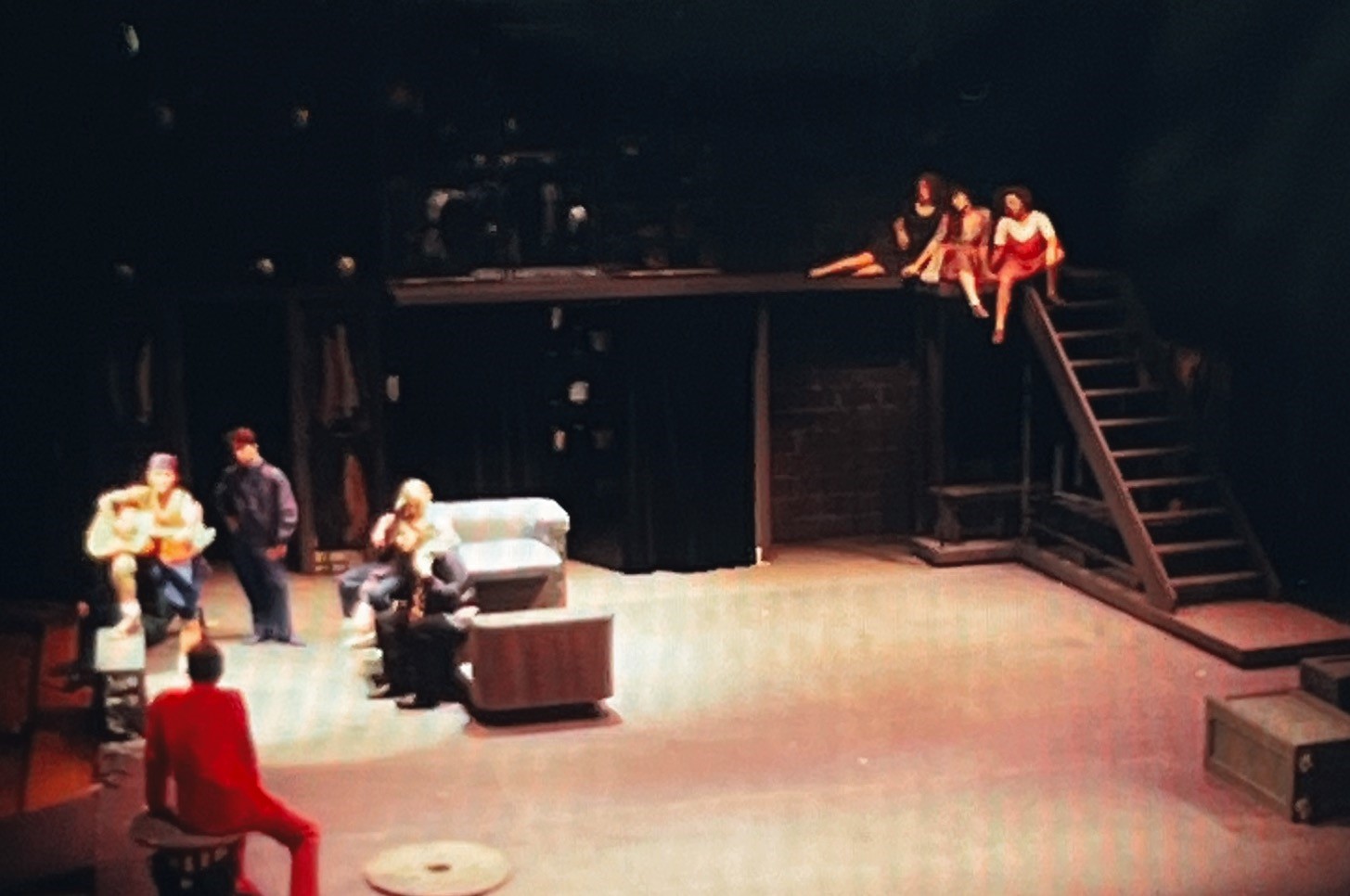 A slightly blurry photograph of actors performing Twelfth Night on the Weisiger Theatre stage.