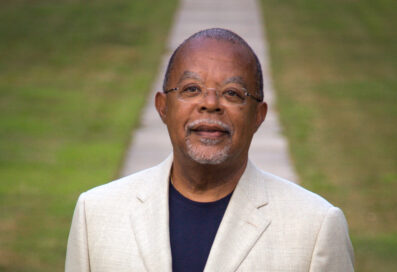 Henry Louis Gates, Jr. Posing For A Portrait In Front Of A Concrete Path And Grassy Lawn