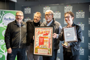 Steve Hoffman, Graham Parker of the Louisville Orchestra, Danville Mayor JH Atkins, and Louisville Orchestra conductor Teddy Abrams pose with a key to Danville and a signed poster.