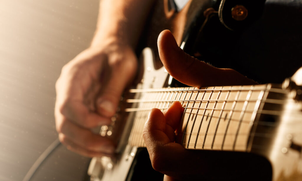 Close-up of hands playing a guitar