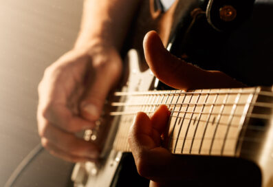 Close-up Of Hands Playing A Guitar