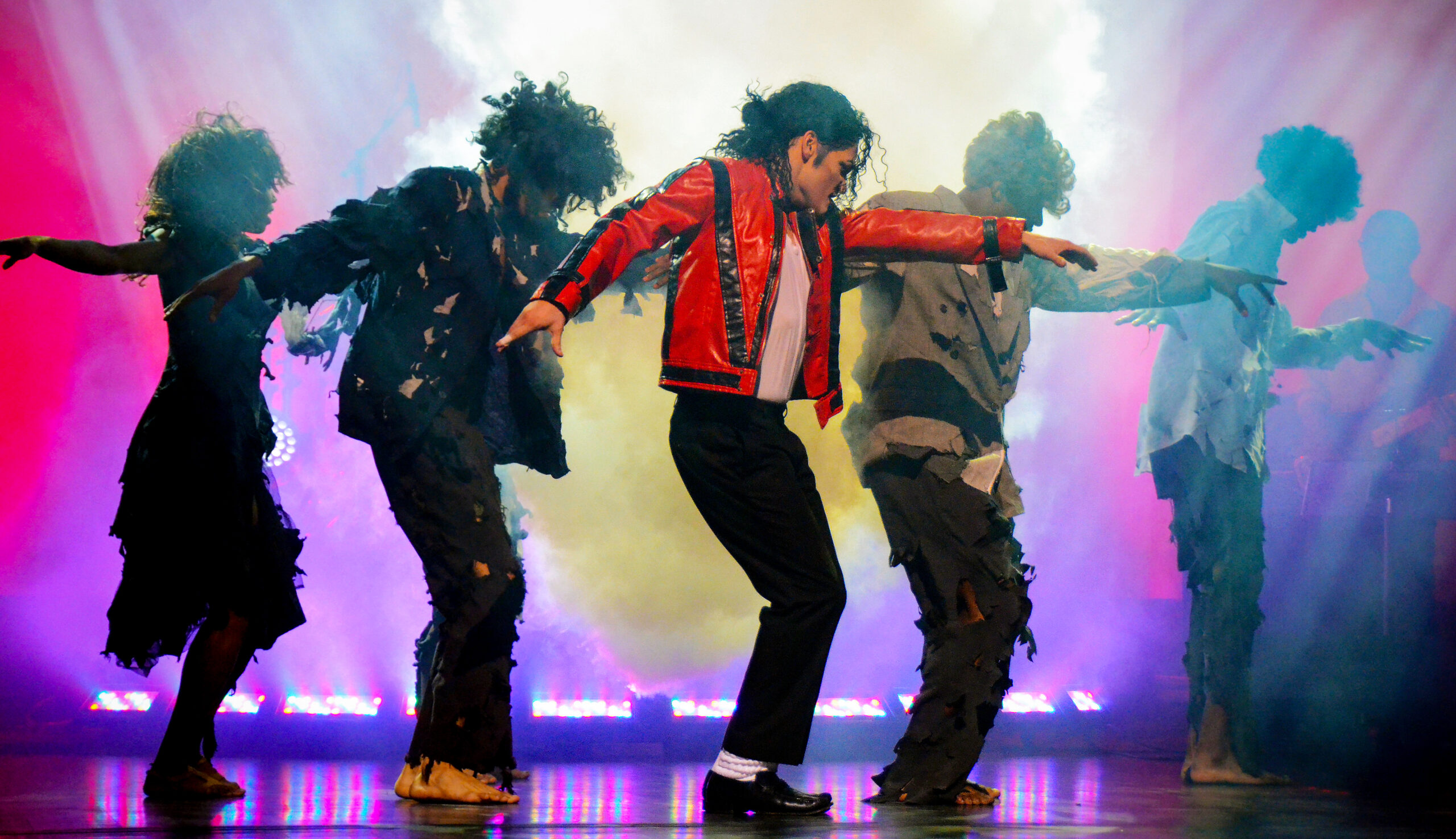 Michael Jackson tribute band on stage dancing "Thriller"