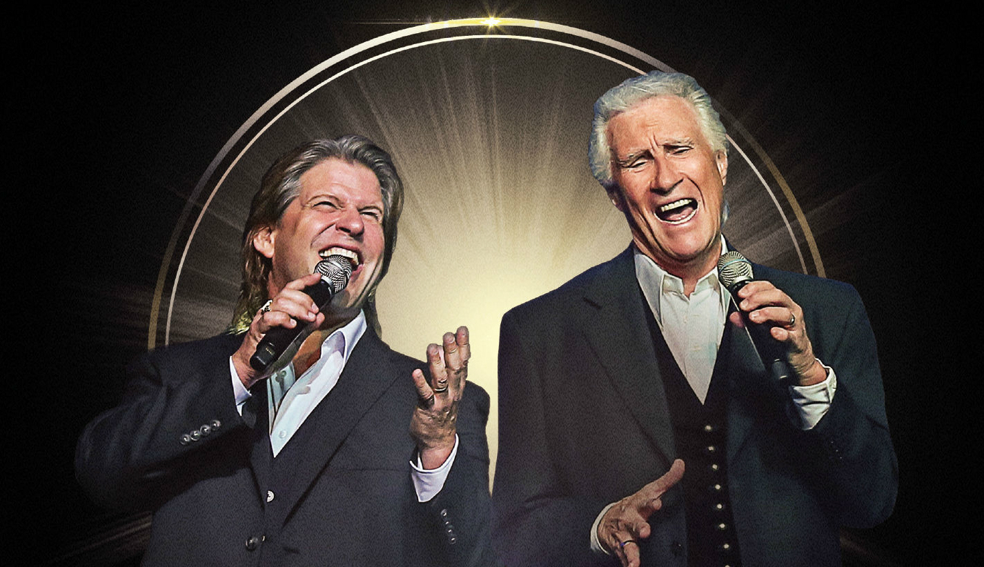 Bill Medley and Bucky Herd singing into microphones