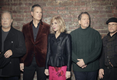 Alison Krauss And Union Station Members Posing Against A Brick Wall