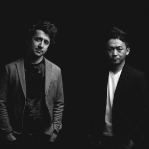 Black and white photo of the two members of House of Waters, posing against a dark backdrop