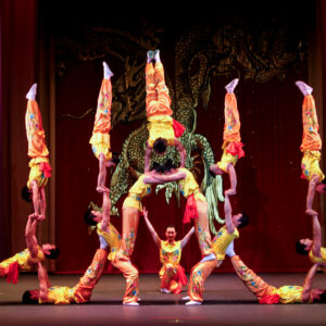 The Peking Acrobats performing a stunt that looks like a human tower