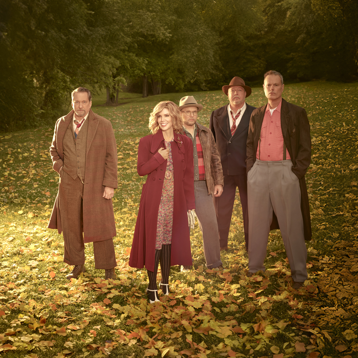 Alison Krauss and Union Station standing in leaf-covered field