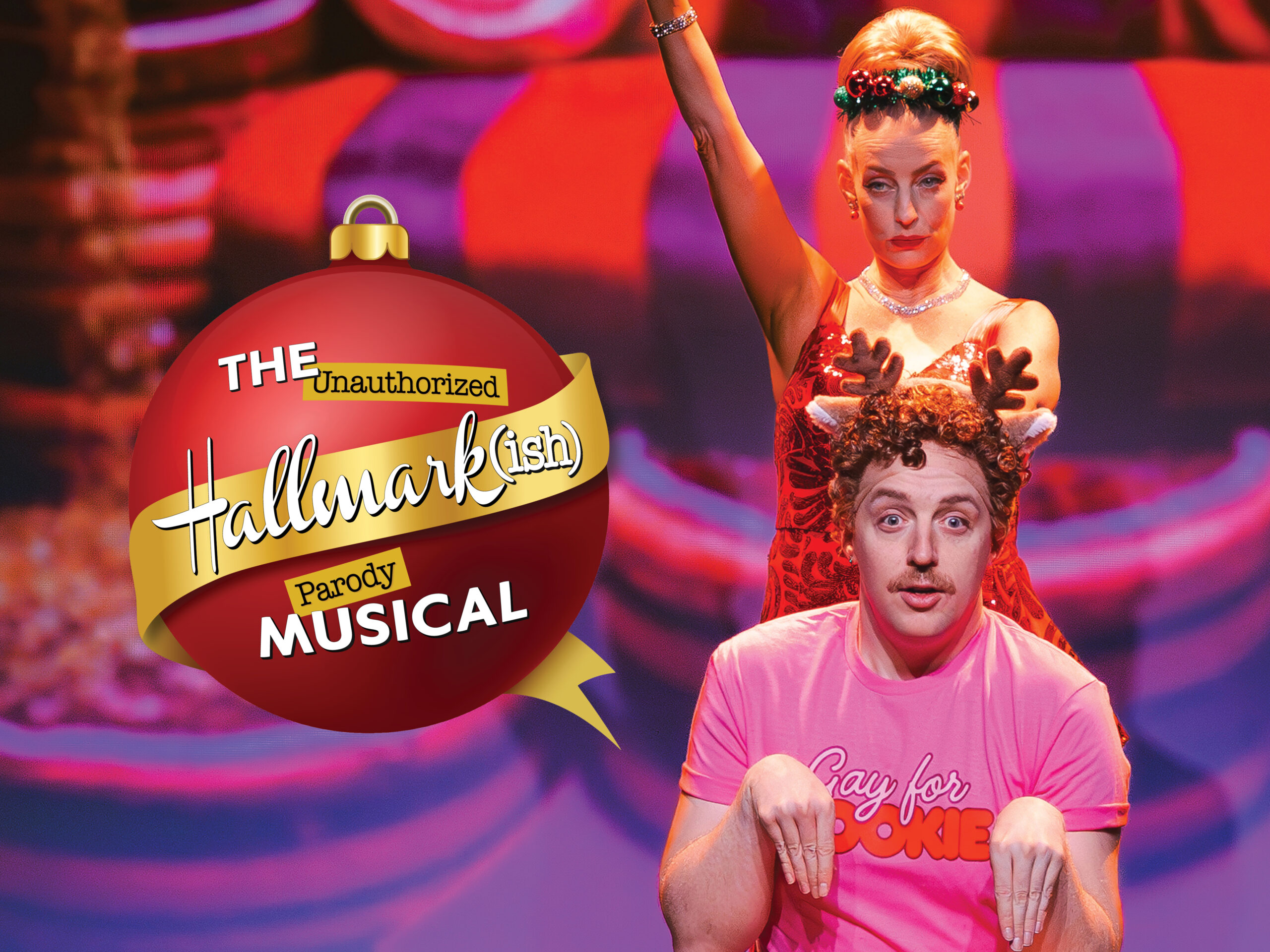 A man pretending to be a reindeer sits in front of a woman wearing a holiday outfit. On the left part of the image is an ornament-shaped logo for The Hallmarkish Parody Musical