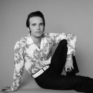 Black and white portrait of Theo Lawrence sitting on the ground