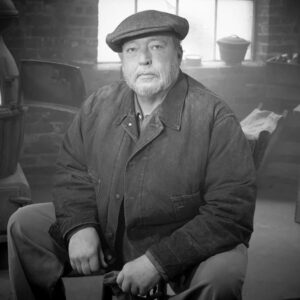 Black and white portrait of Russell Moore sitting on a chair